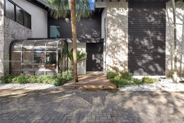 entrance to property featuring stone siding