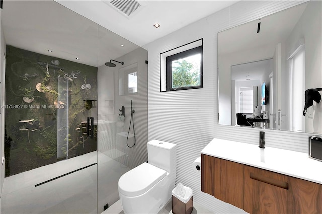 full bath featuring toilet, vanity, visible vents, tile walls, and walk in shower