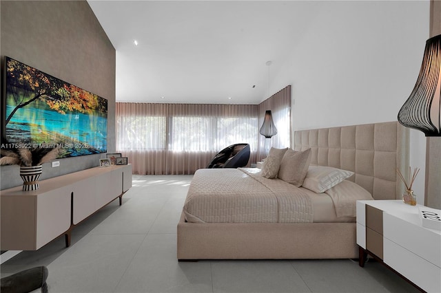 bedroom with a high ceiling and light tile patterned flooring