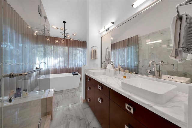 bathroom with double vanity, a soaking tub, marble finish floor, a shower stall, and a sink