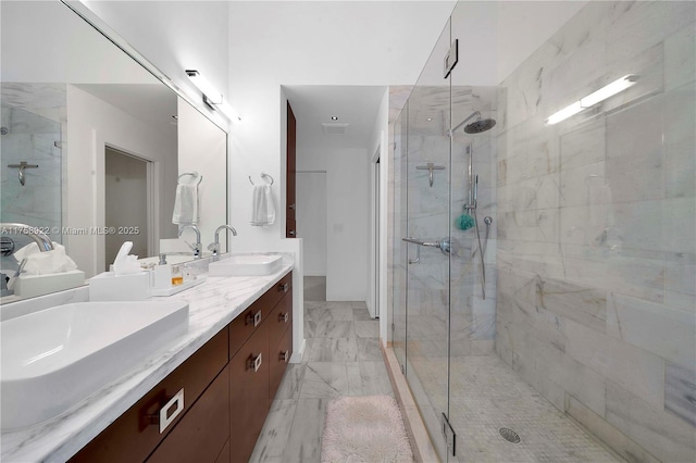 full bath featuring marble finish floor, a sink, and a shower stall