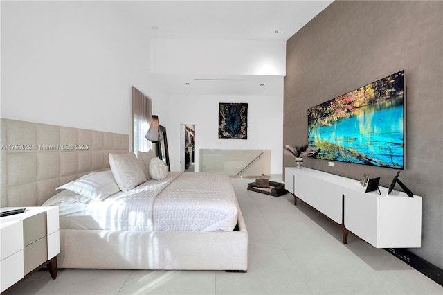 bedroom featuring a towering ceiling