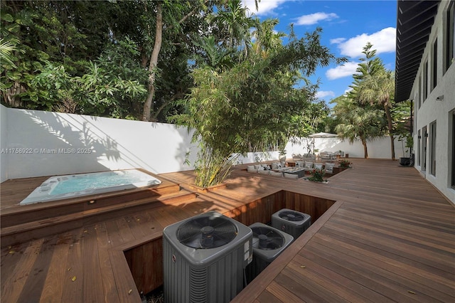 deck featuring outdoor dining area, central AC, and fence