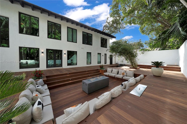 exterior space featuring an outdoor living space with a fire pit