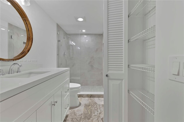 bathroom with toilet, recessed lighting, vanity, a closet, and a stall shower