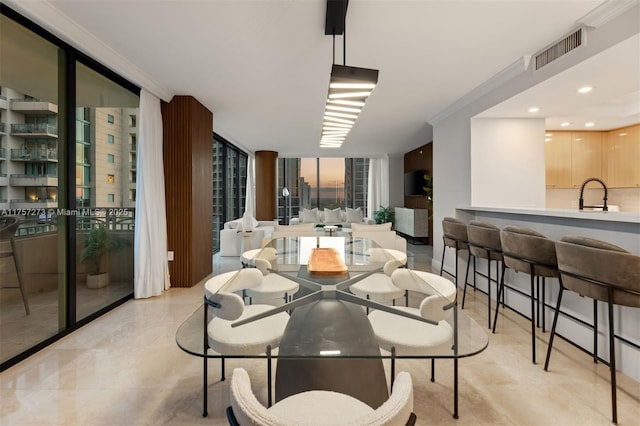 dining room featuring visible vents, floor to ceiling windows, and crown molding