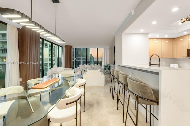 dining space featuring recessed lighting and expansive windows