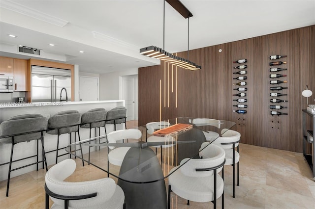 dining area with recessed lighting, visible vents, wood walls, and crown molding