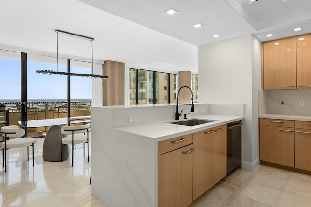 kitchen with floor to ceiling windows, dishwasher, light countertops, a peninsula, and a sink