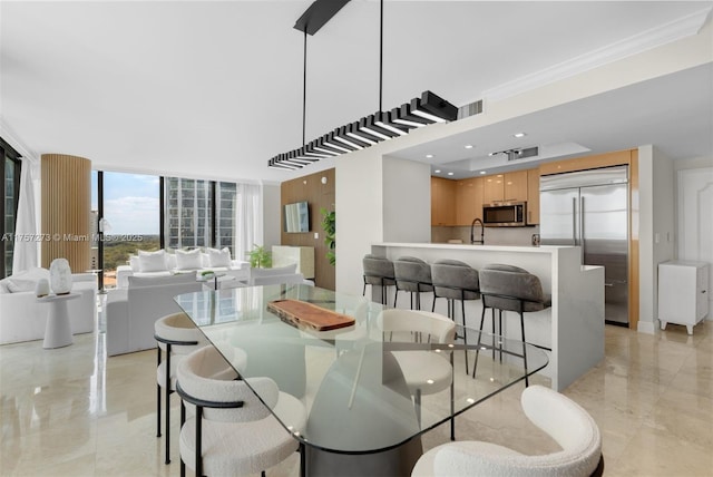 dining area with floor to ceiling windows, visible vents, marble finish floor, and ornamental molding