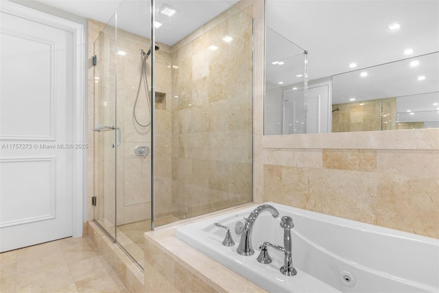 full bathroom with recessed lighting, a shower stall, and a jetted tub