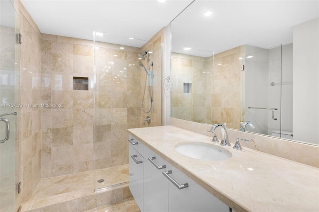 full bathroom featuring a shower stall and vanity