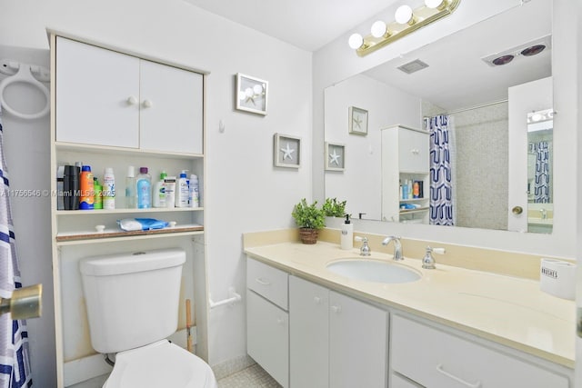 bathroom featuring visible vents, a shower with shower curtain, vanity, and toilet