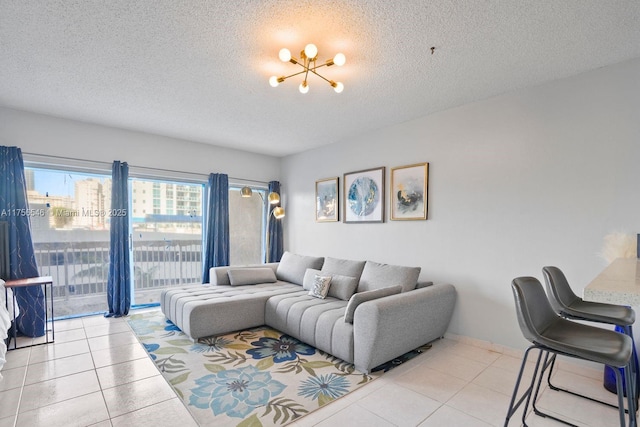 living area featuring tile patterned flooring, a chandelier, and a textured ceiling