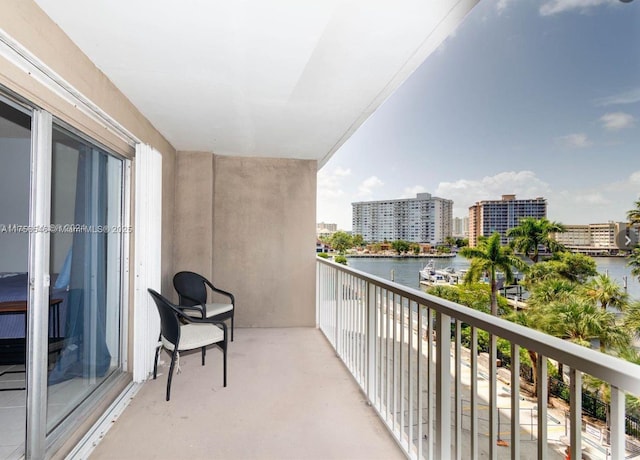 balcony featuring a view of city and a water view