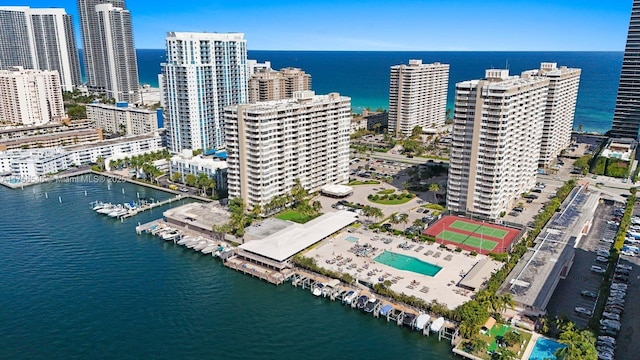 birds eye view of property featuring a water view and a city view