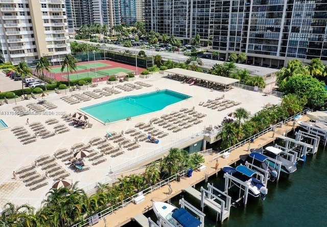 view of swimming pool with a water view and a view of city