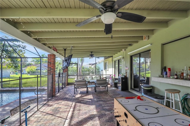 view of patio with glass enclosure and ceiling fan