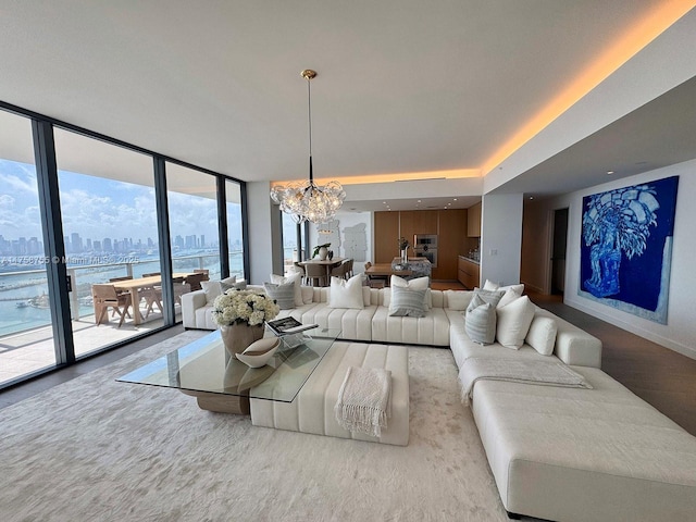 501 W Ave Unit 4202, Miami Beach, FL 33139 - living area featuring baseboards, a wall of windows, a chandelier, wood finished floors, and a city view