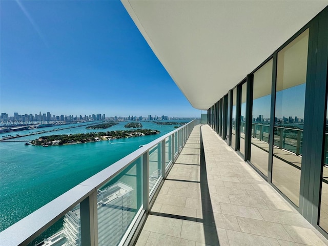 balcony with a water view and a city view