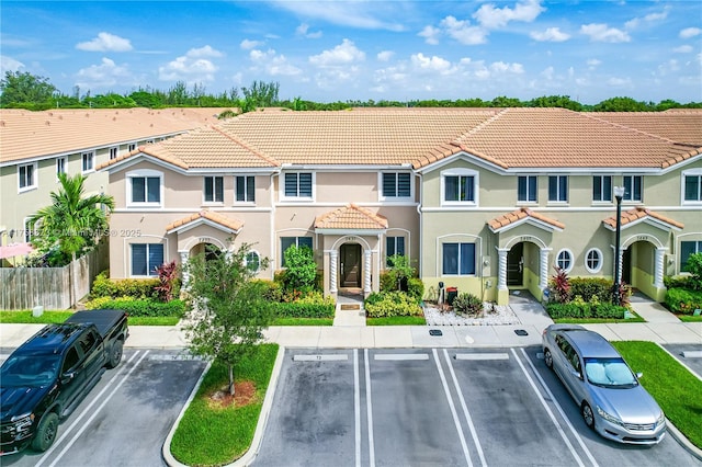 2431 SE 10th Ct, Homestead, FL 33035 - view of front facade with uncovered parking, a tile roof, and stucco siding
