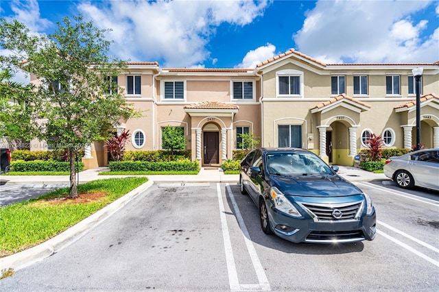 2431 SE 10th Ct, Homestead, FL 33035 - view of front of property featuring stucco siding, uncovered parking, and a tiled roof