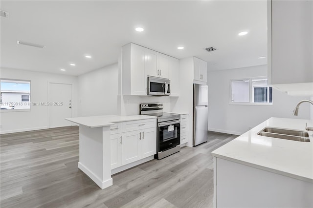 kitchen featuring recessed lighting, a sink, visible vents, light countertops, and appliances with stainless steel finishes