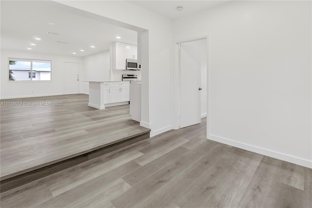 interior space with recessed lighting, baseboards, and light wood finished floors