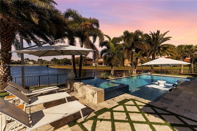 11360 NW 83rd Way, Parkland, FL 33076 - pool at dusk featuring fence, a water view, and a patio