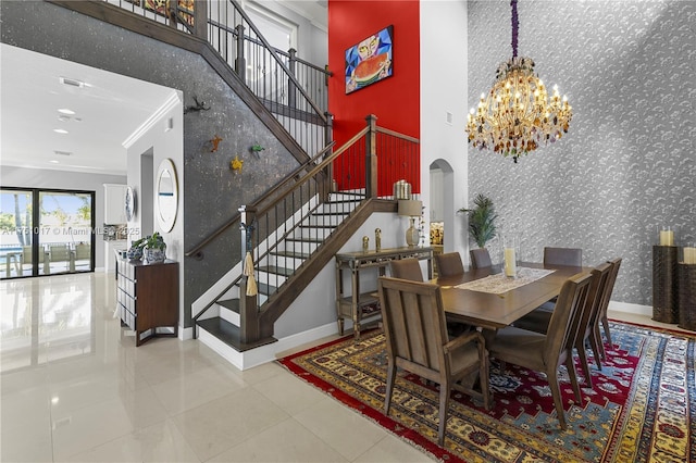 dining space with wallpapered walls, arched walkways, stairs, an accent wall, and a notable chandelier