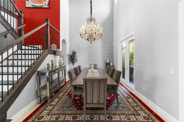 11360 NW 83rd Way, Parkland, FL 33076 - dining room with stairs, wallpapered walls, an inviting chandelier, french doors, and baseboards