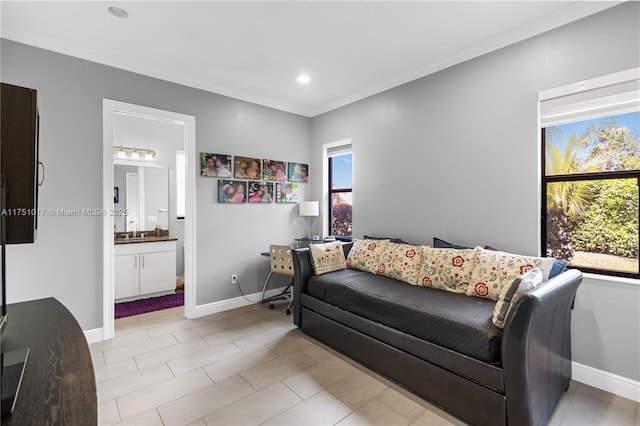 living room with a healthy amount of sunlight, crown molding, and baseboards