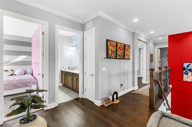 corridor with visible vents, an upstairs landing, ornamental molding, wood finished floors, and recessed lighting