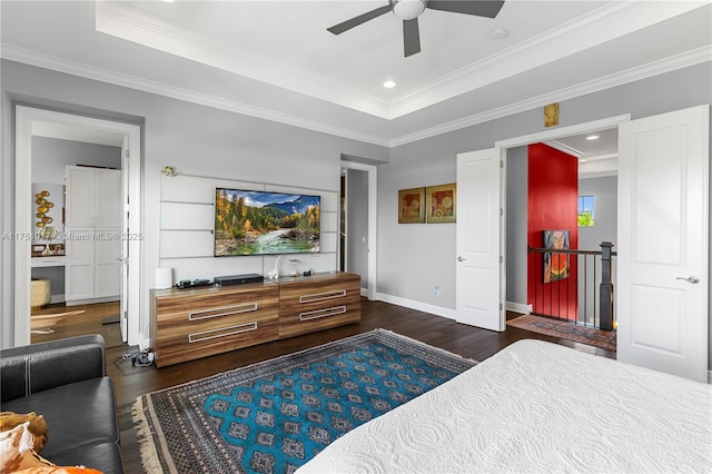 bedroom featuring a raised ceiling, ornamental molding, baseboards, ceiling fan, and dark wood-style flooring