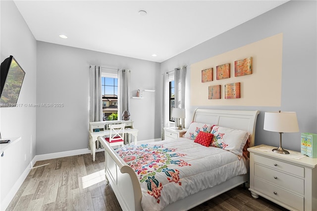 bedroom with recessed lighting, baseboards, and wood finished floors