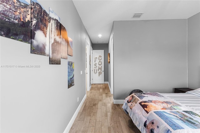 bedroom with visible vents, baseboards, and light wood-style flooring