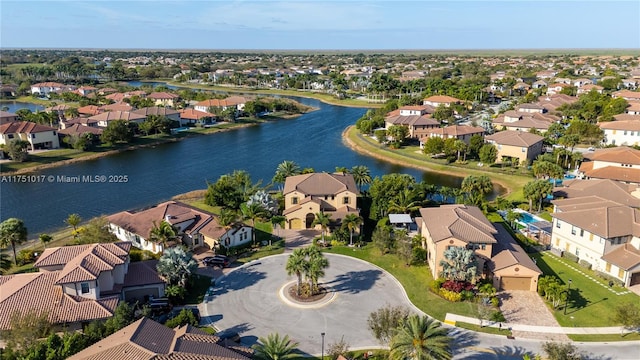 drone / aerial view with a residential view and a water view