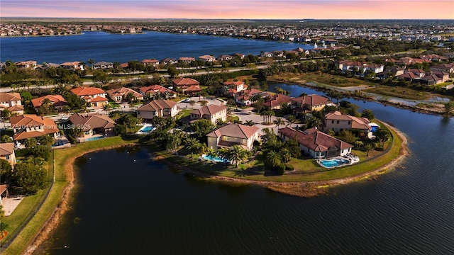 drone / aerial view featuring a residential view and a water view