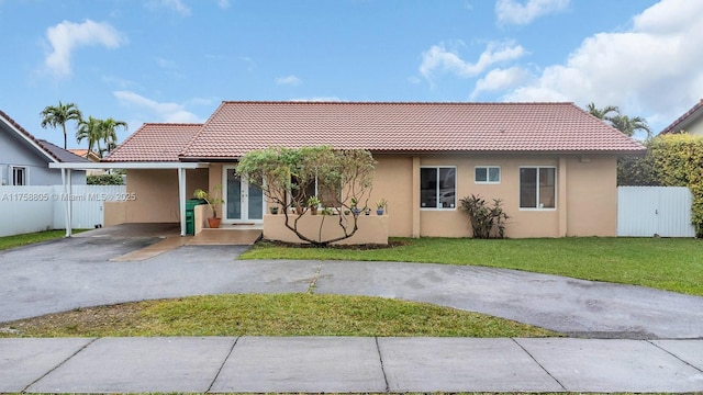 340 SW 132nd Ave, Miami, FL 33184 - view of front of property featuring fence, aphalt driveway, a tile roof, a front yard, and stucco siding