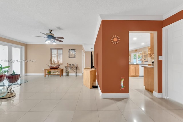 living room with light tile patterned flooring, a ceiling fan, visible vents, and a healthy amount of sunlight