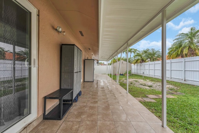 view of patio with a fenced backyard, a shed, and an outdoor structure