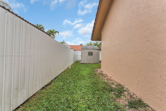 view of yard featuring a shed, fence private yard, and an outdoor structure