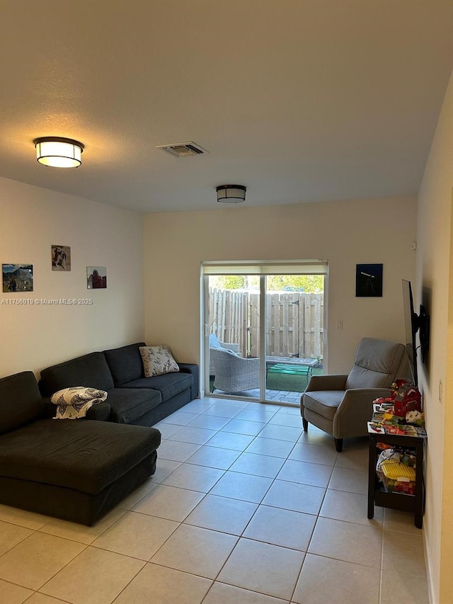 living room with light tile patterned floors and visible vents