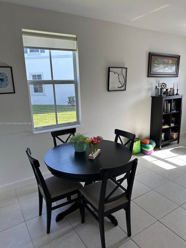 dining room featuring light tile patterned flooring and baseboards