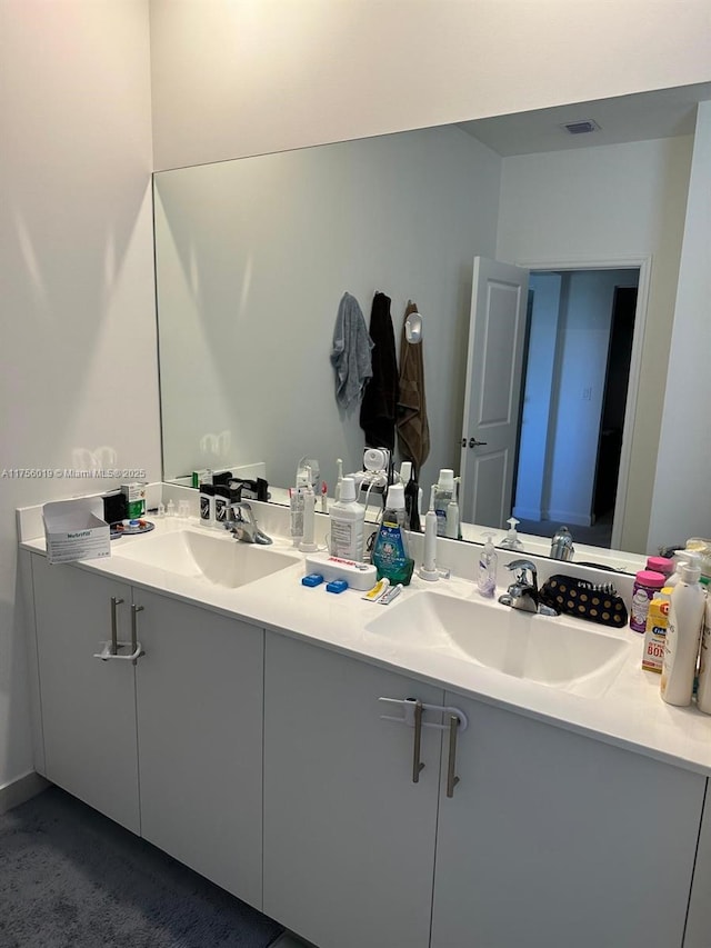 bathroom with a sink and double vanity