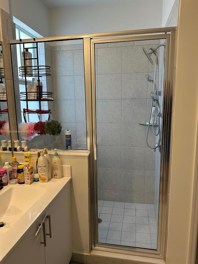 full bathroom featuring a shower stall and vanity