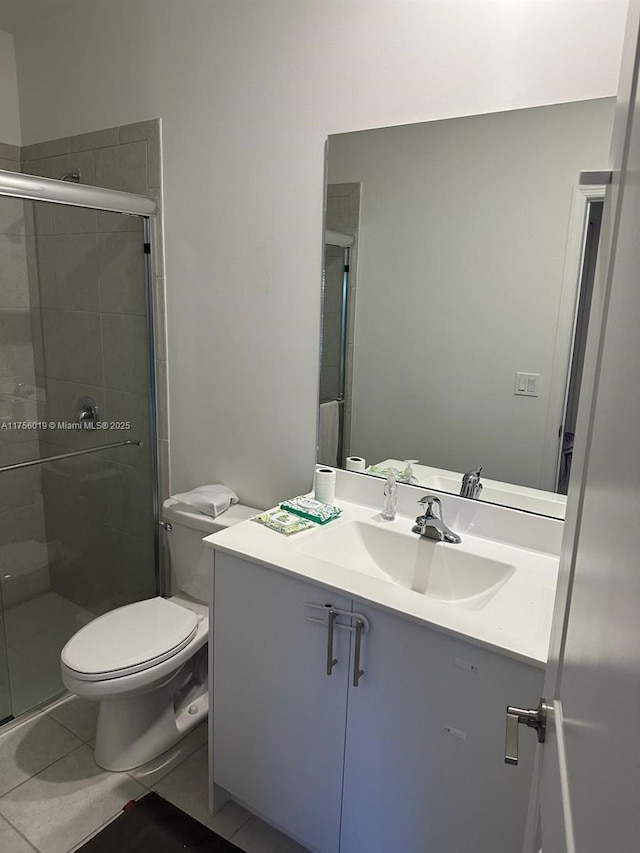 full bath featuring toilet, a shower stall, tile patterned flooring, and vanity