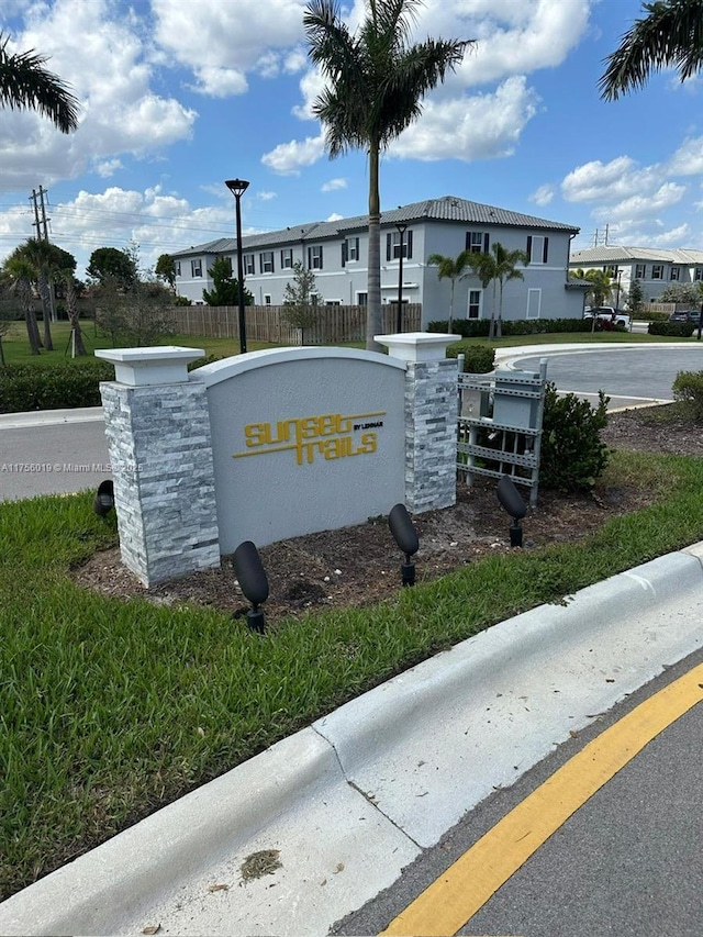 community / neighborhood sign featuring fence