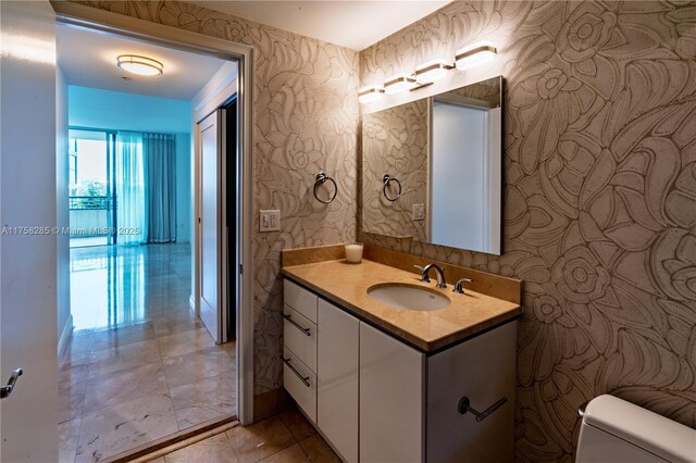 3400 SW 27th Ave Unit 705, Miami, FL 33133 - half bath with wallpapered walls, toilet, and vanity