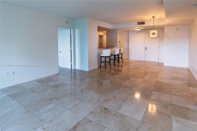 3400 SW 27th Ave Unit 705, Miami, FL 33133 - spare room featuring baseboards, marble finish flooring, and a chandelier